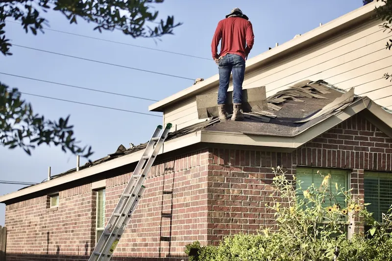 Professional roofer working on a residential roof in Virginia